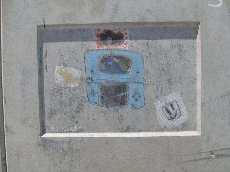 Child's chalk image of a Nintendo DS, drawn on a wall.