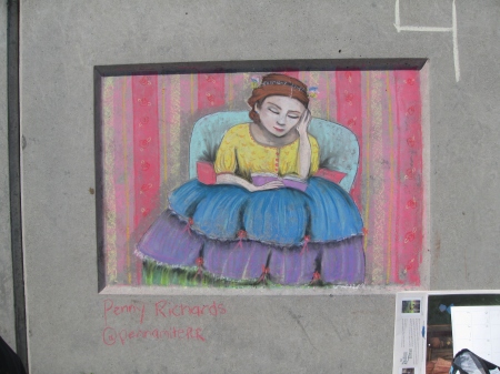 panel of chalk art, woman with voluminous skirts reading.