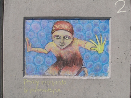 Human figure with bubble background, drawn in chalk on a wall.